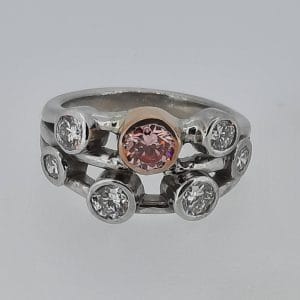 0.53CT vivid pink certificated lab grown diamond set with white lab grown diamonds in a platinum bubble ring (4)